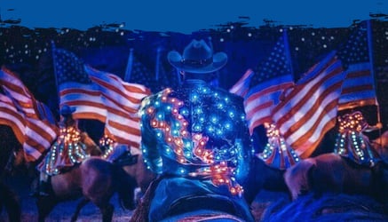 A red white and blue costume and American flags in Stampede patriotic finale