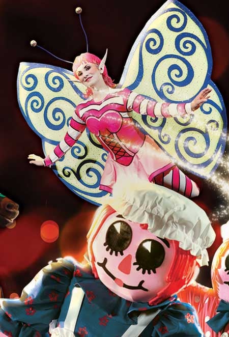 Christmas toys come to life, A sugar plum fairy flies in the background as giant dolls come to life below