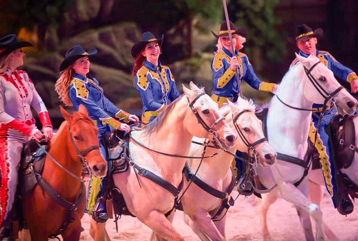 Cast of trick riders on horses at Dolly Parton’s Stampede in Pigeon Forge