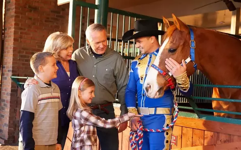 family meeting a horse at Dolly Parton's Stampede